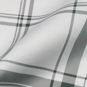 Detail of high-waist plaid shorts fabric showing fine gray and white textile texture