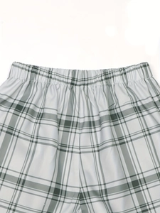 Detail of elastic high waist with plaid pattern on casual retro checked shorts