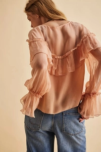 Detailed back view of a light pink chiffon blouse with ruffled layers and ribbed texture