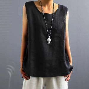 Detail of black cotton linen sleeveless top featuring a chest pocket and natural fabric texture