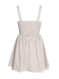 Detailed view of the white polka dot dress with elastic smocking and delicate lace trim