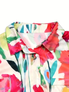 Detailed view of colorful abstract floral print and button-down collar on linen shirt