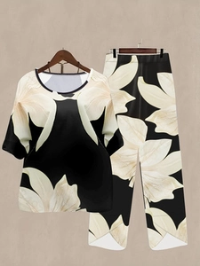 Detail of floral print on two-piece set featuring wide-leg pants and a round-neck top