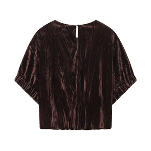 Detail of dark brown velvet top featuring a back teardrop opening and button closure