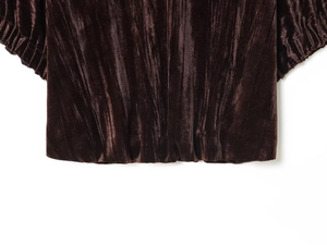 Detail view of coffee brown velvet fabric with glossy texture and gathered ruching design