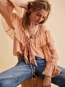 Elegant peach chiffon long sleeve blouse with ruffled layers and a front tie detail