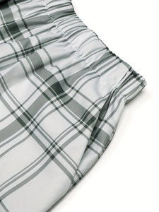 Retro high-waisted plaid shorts with green and white checks and elastic waistband