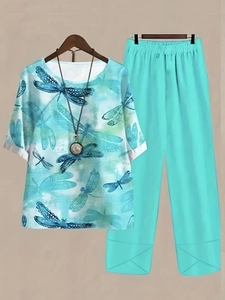 Detail of the dragonfly print top and elastic waist trousers on wooden hangers