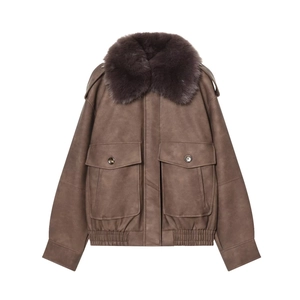 Detail of a brown aviator leather jacket with faux fur collar and large flap pockets