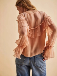 Elegant peach chiffon blouse featuring delicate ruffles and flared sleeves back view