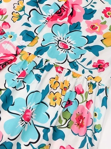 Women's floral short sleeve summer dress featuring colorful prints and button details