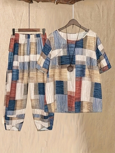 Women's two-piece casual set featuring a floral round neck top and loose fitting trousers