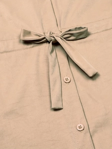 Beige safari style short sleeve shirt with waist drawstring and button-down details