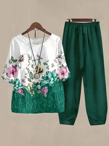 Detailed view of women's two-piece casual set featuring floral print top and green wide trousers