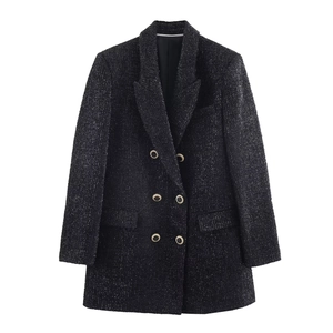 Detail of black tweed blazer with metallic threads and gold double-breasted buttons