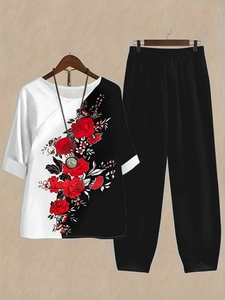 Detail of crew neck top with realistic red rose floral print and contrast patchwork design