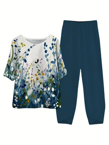 Detail view of floral print top and solid pants with criss-cross slit at the hemline