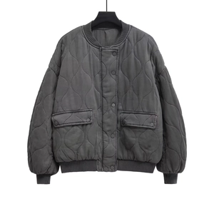 Detail of grey quilted bomber jacket featuring classic onion stitching and ribbed cuffs