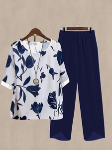 Detailed flat lay of women's floral crew neck top and navy wide-leg pants set