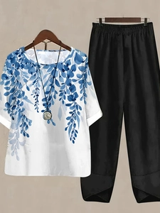 Close-up of women's two-piece set with floral top and tulip-hem slit trousers