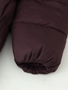 Close-up of quilted winter puffer jacket showing elasticated cuffs and windproof fabric
