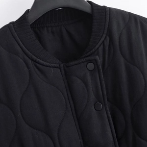 Women's black quilted bomber jacket with ribbed collar and snap button closure details