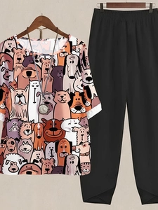 Detail of floral dog print short sleeve top and black pants with asymmetric hem