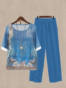 Detail of floral print two-piece set featuring short sleeve top and wide-leg trousers