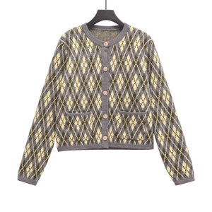 Detailed view of argyle knit cardigan featuring vintage metal buttons and front pockets