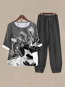 Close-up of women's grey two-piece set featuring white floral print and linen texture