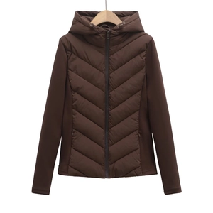 Detail of dark brown hooded jacket featuring chevron quilting and contrast sleeve textures