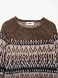 Close-up of fluffy jacquard knit sweater with round neck and vintage brand label