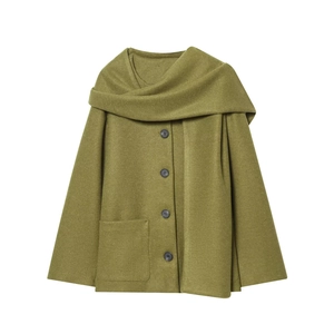Detail of dark green wool coat showing integrated scarf collar and textured fabric