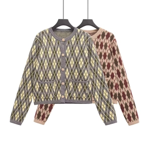 Flat lay of women's argyle knit cardigans in gray-yellow and pink color schemes