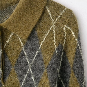Detail of olive green and grey argyle knit pattern with fuzzy mohair texture