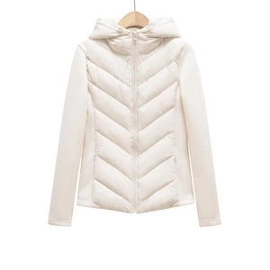Detail of white hooded puffer jacket featuring V-shaped quilted stitching and zipper closure