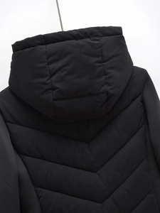 Detail view of the black hooded puffer jacket with premium Chevron quilting on the back