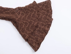 Close-up of coffee brown hollow mesh knit fabric showing flared cuff texture and weave