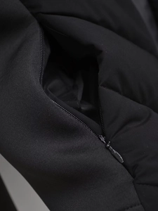 Detail showing the invisible zipper and matte texture on a black winter jacket