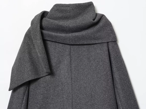 Detail of grey wool coat showing high-quality fabric texture and scarf collar design