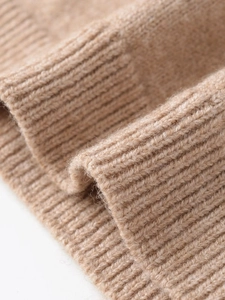 Macro shot of fine camel knit texture with ribbed cuffs for women's autumn sweater