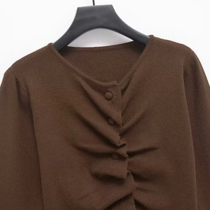 Dark brown ruched knit sweater with decorative buttons and elegant round neck design