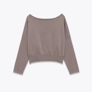 Detail view of mauve knit sweater showing the ribbed cuffs and wide neckline texture