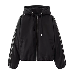 Detail of black hooded jacket featuring silver zipper and white stripes on sleeves