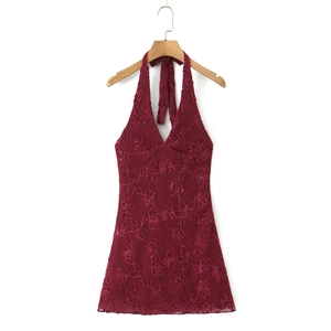 Close-up of dark red halter dress with intricate mesh embroidery and sequin details