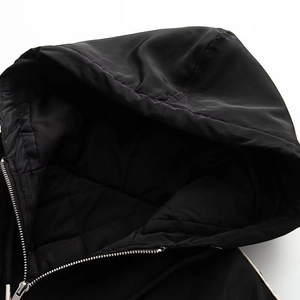 Macro shot of hood lining and metallic silver zipper on the black padded winter jacket