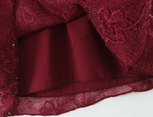 Detail of the mesh tulle hem with sequins and lining on this burgundy party dress