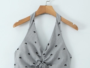 Detailed view of grey halter neck top with 3D rose flower and black floral patterns