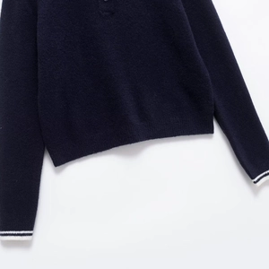 Navy blue knitted sweater with white stripe sleeves and wide ribbed hem detail