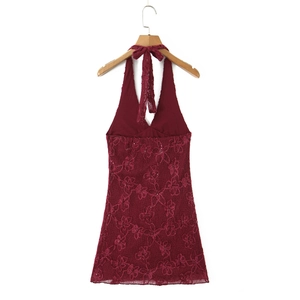 Close-up of wine red halter dress showing intricate lace floral embroidery and sequins